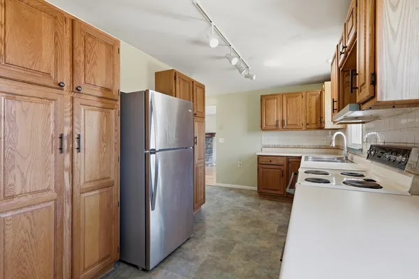 a kitchen with stainless steel appliances a refrigerator and a stove top oven