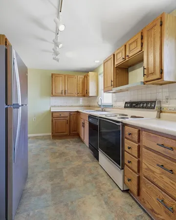a kitchen with stainless steel appliances granite countertop a sink and cabinets