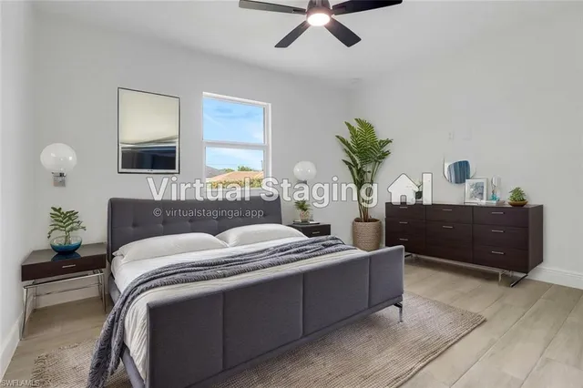 a living room with a bed furniture and a potted plant