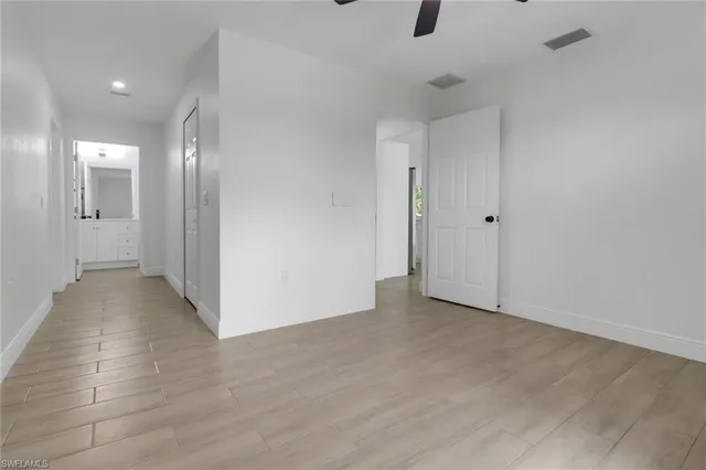a view of an empty room with wooden floor