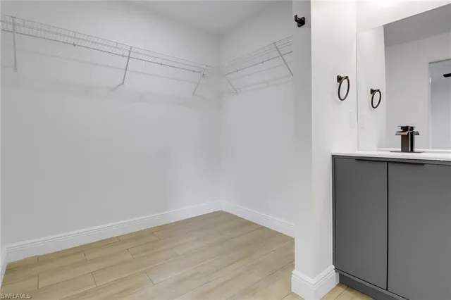 a view of a room with wooden floor and cabinet