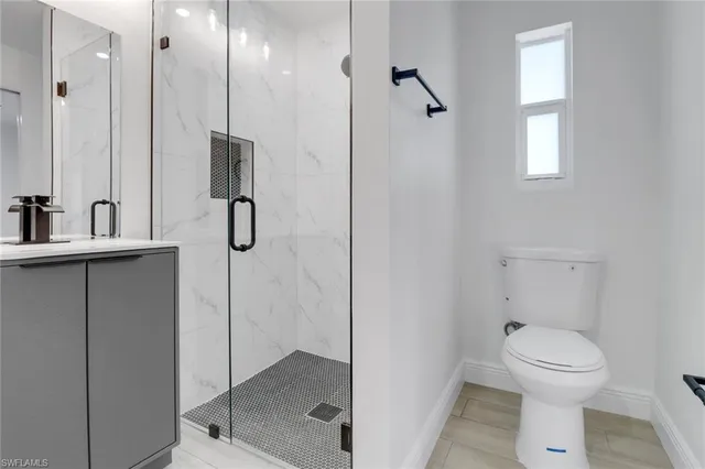 a bathroom with a toilet a sink and shower