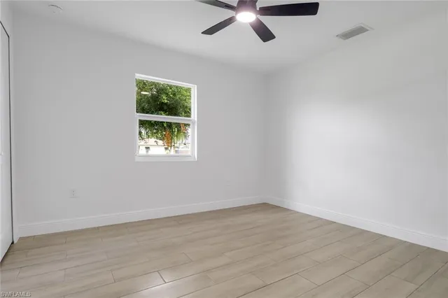 wooden floor in an empty room with a window