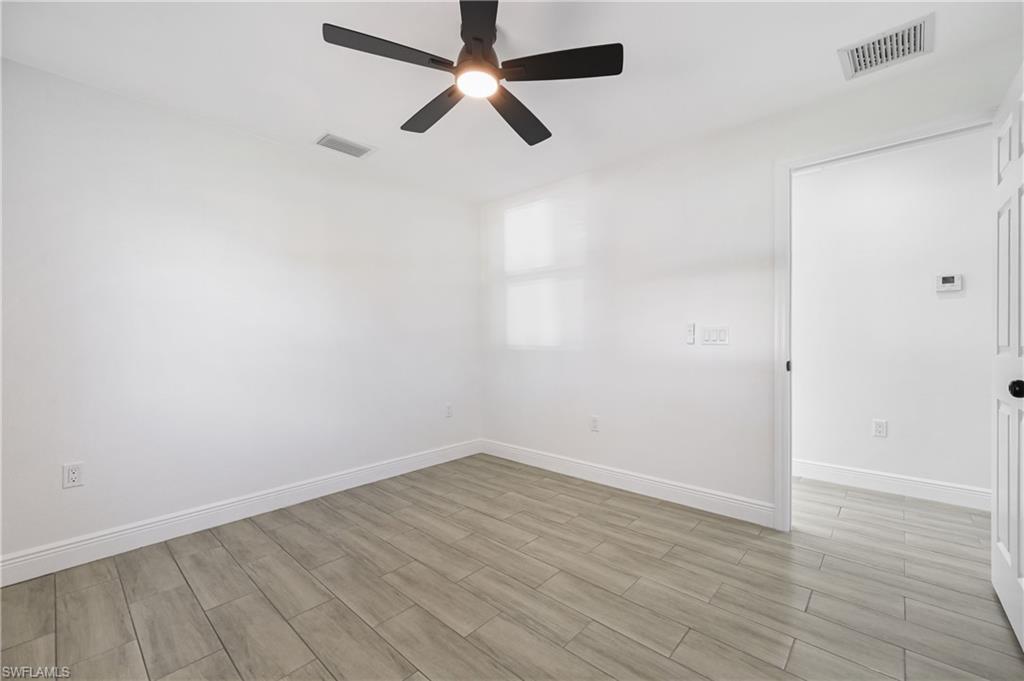 4448 18th Avenue Southwest Naples, FL 34116 - Photo 24 of 40 Unfurnished room featuring wood tiled floors and a ceiling fan