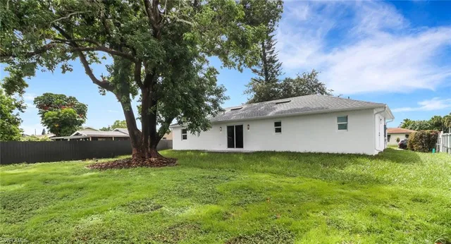 a white house that has a tree in it