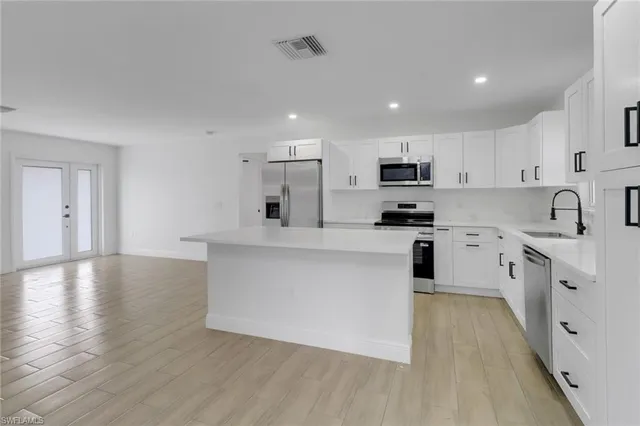 a kitchen with granite countertop a sink and cabinets