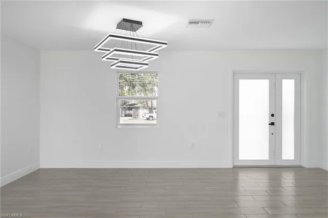 a view of a kitchen with furniture and wooden floor