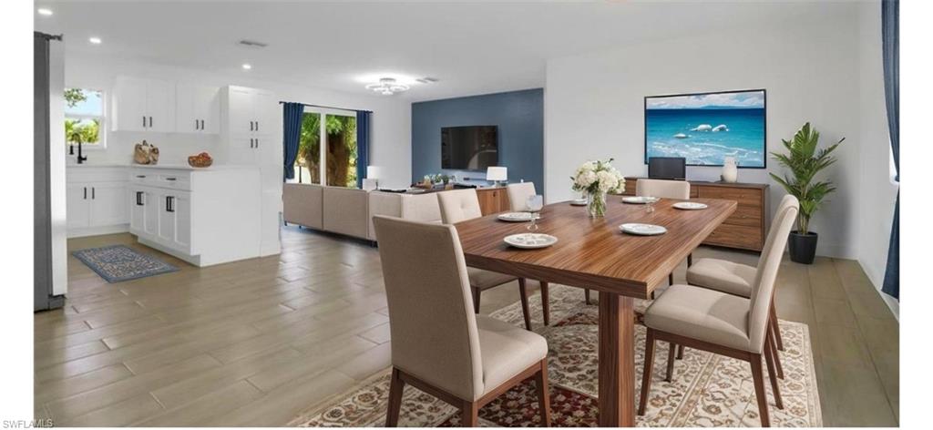 4448 18th Avenue Southwest Naples, FL 34116 - Photo 9 of 40 a view of a dining room with furniture and wooden floor