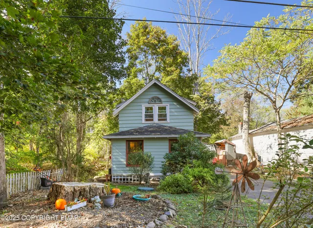 a front view of house with yard and trees around