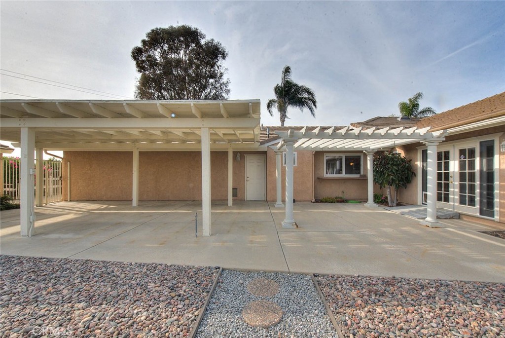 30673 Del Rey Road Temecula, CA 92591 - Photo 35 of 47 Side View Of Patio Cover. Door In Middle Leads To Garage. Window Is Pass Thru From Kitchen To Facilitate Outdoor Meals. Double Doors To Right To Bonus Room.