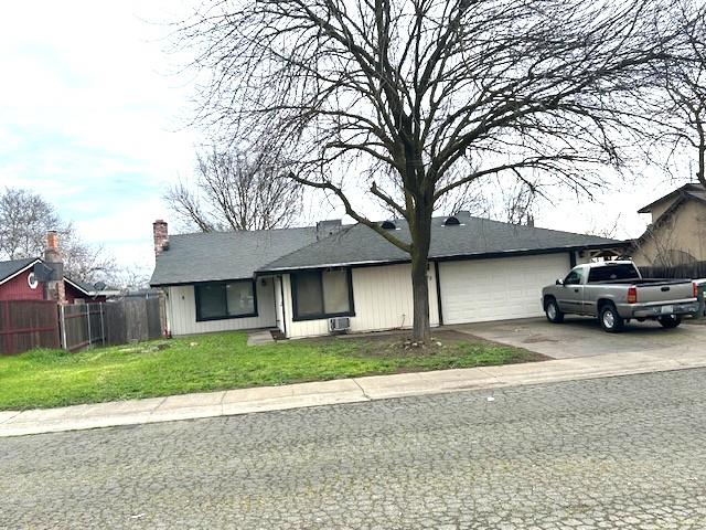 Absolutely Gorgeous view of the Front of this Home with a Large driveway with RV Access on right side to the back yard.