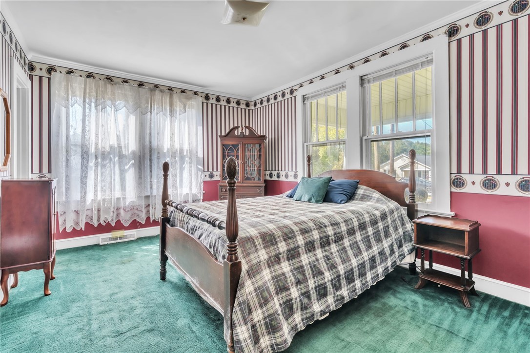 121 Ellison Street Belton, SC 29627 - Photo 13 of 30 This cozy bedroom features plush carpeting, large windows, and classic trim details.
