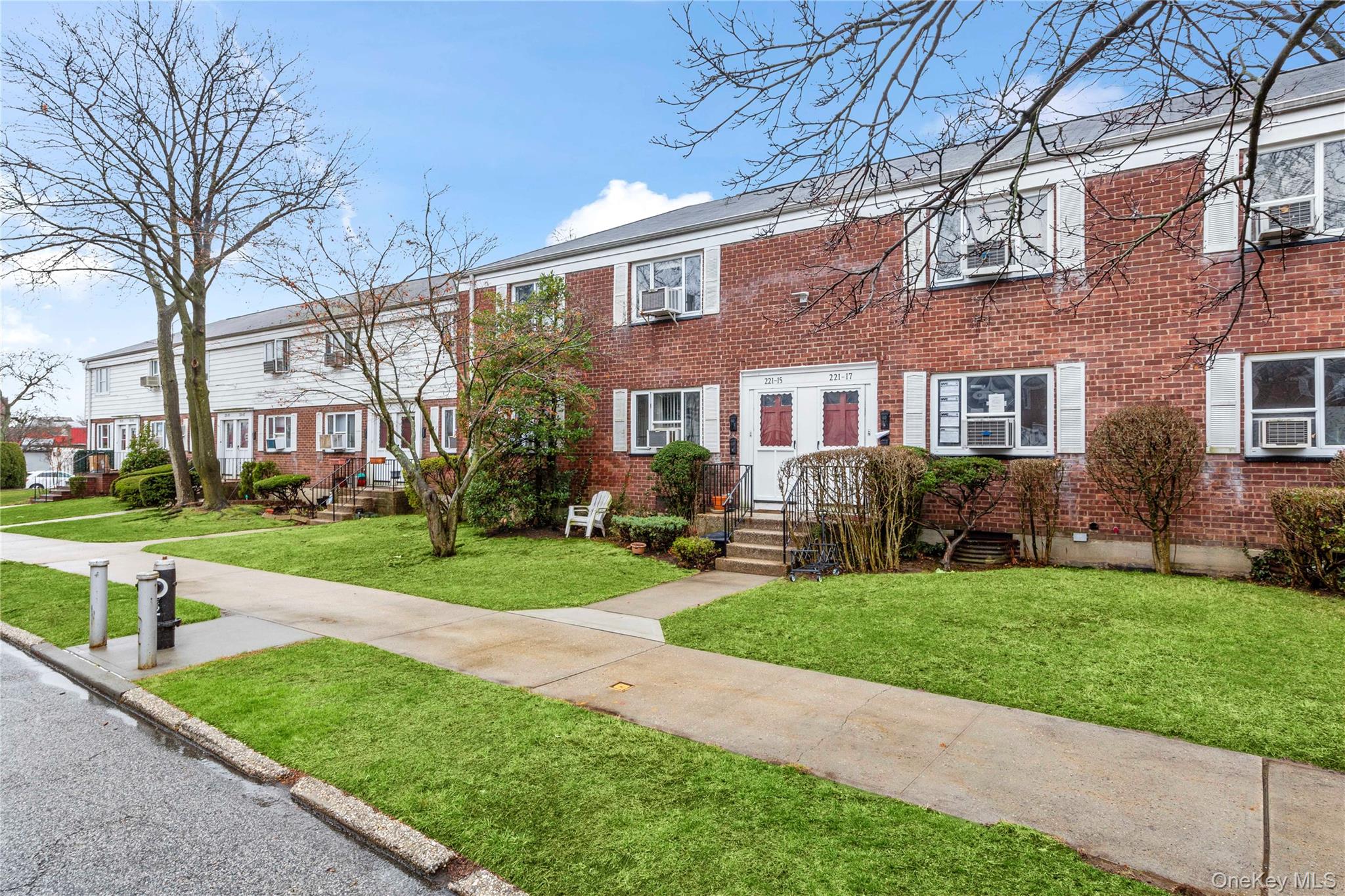 221-15 Manor Road, Unit UPPR Queens, NY 11427 - Photo 11 of 16 a front view of house with yard and green space