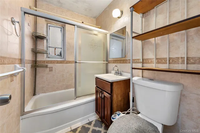a bathroom with a tub sink and mirror