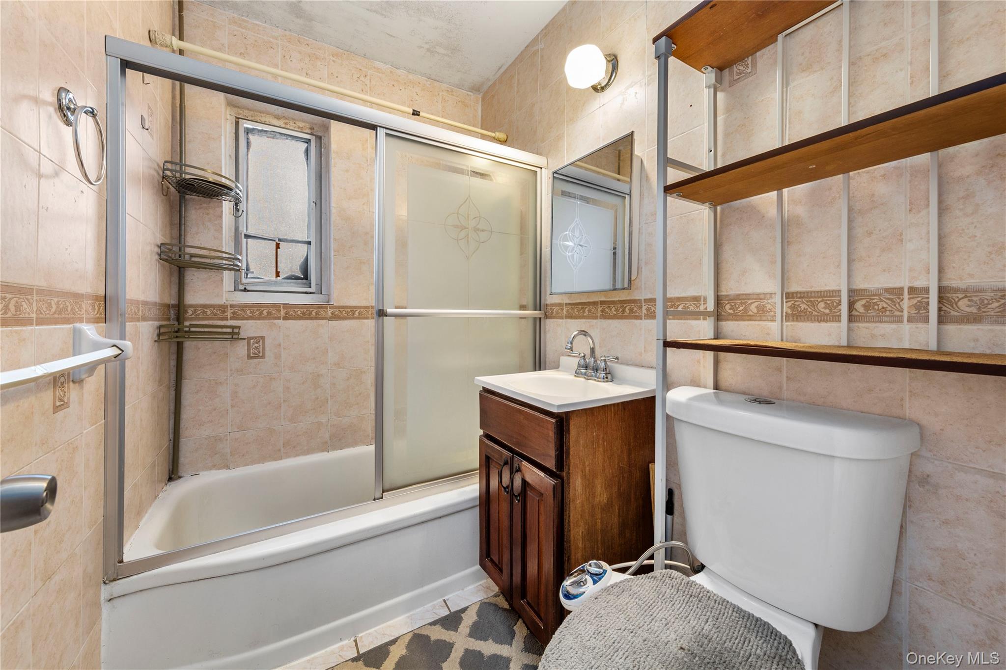 221-15 Manor Road, Unit UPPR Queens, NY 11427 - Photo 12 of 16 a bathroom with a tub sink and mirror