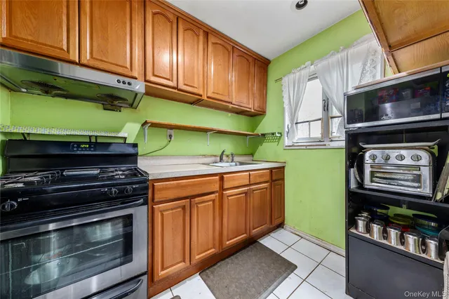 a kitchen with stainless steel appliances a stove and a microwave
