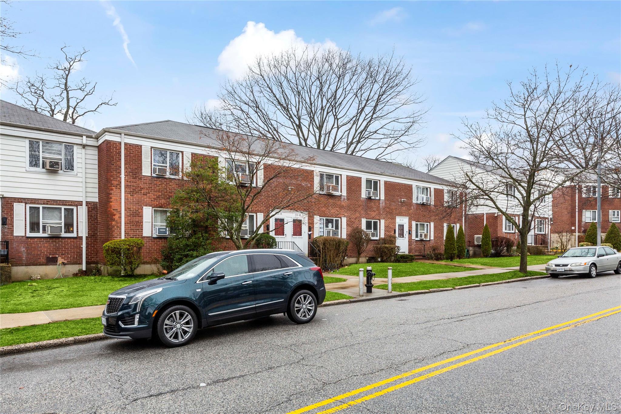 221-15 Manor Road, Unit UPPR Queens, NY 11427 - Photo 5 of 16 a car parked in front of a white house
