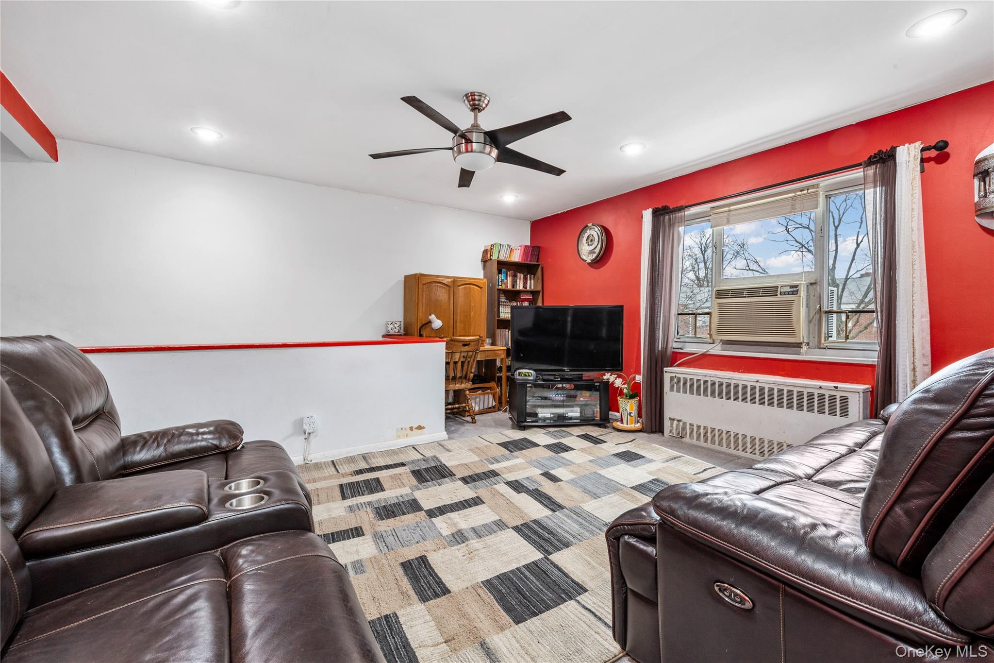 221-15 Manor Road, Unit UPPR Queens, NY 11427 - Photo 6 of 16 a living room with furniture and a flat screen tv