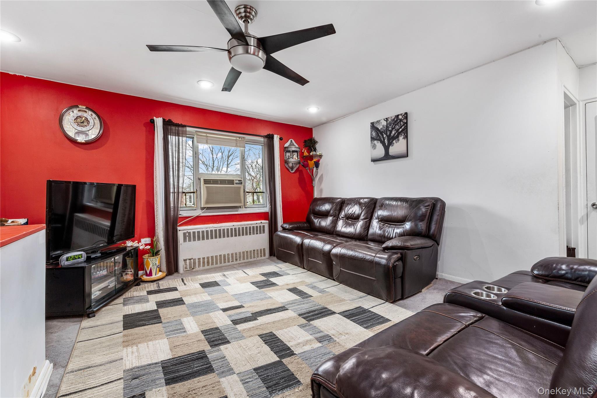 221-15 Manor Road, Unit UPPR Queens, NY 11427 - Photo 7 of 16 a living room with furniture and a flat screen tv