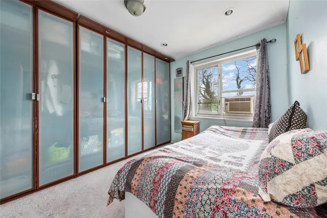 a bedroom with a large bed and a large window