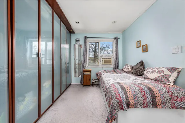 a bedroom with a bed couch and a window