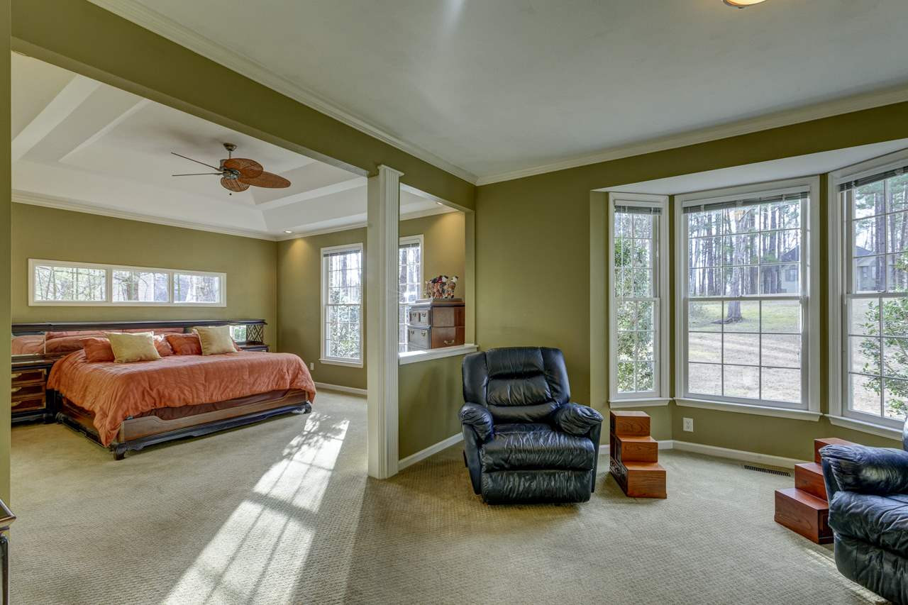 12312 Galway Drive Raleigh, NC 27613 - Photo 11 of 25 The first floor master suite boasts a double step up trey with recessed lighting, ceiling fan, upgraded carpet, triple window, two single windows, and a sitting area with a bay window and built-in cabinets. Master Suite