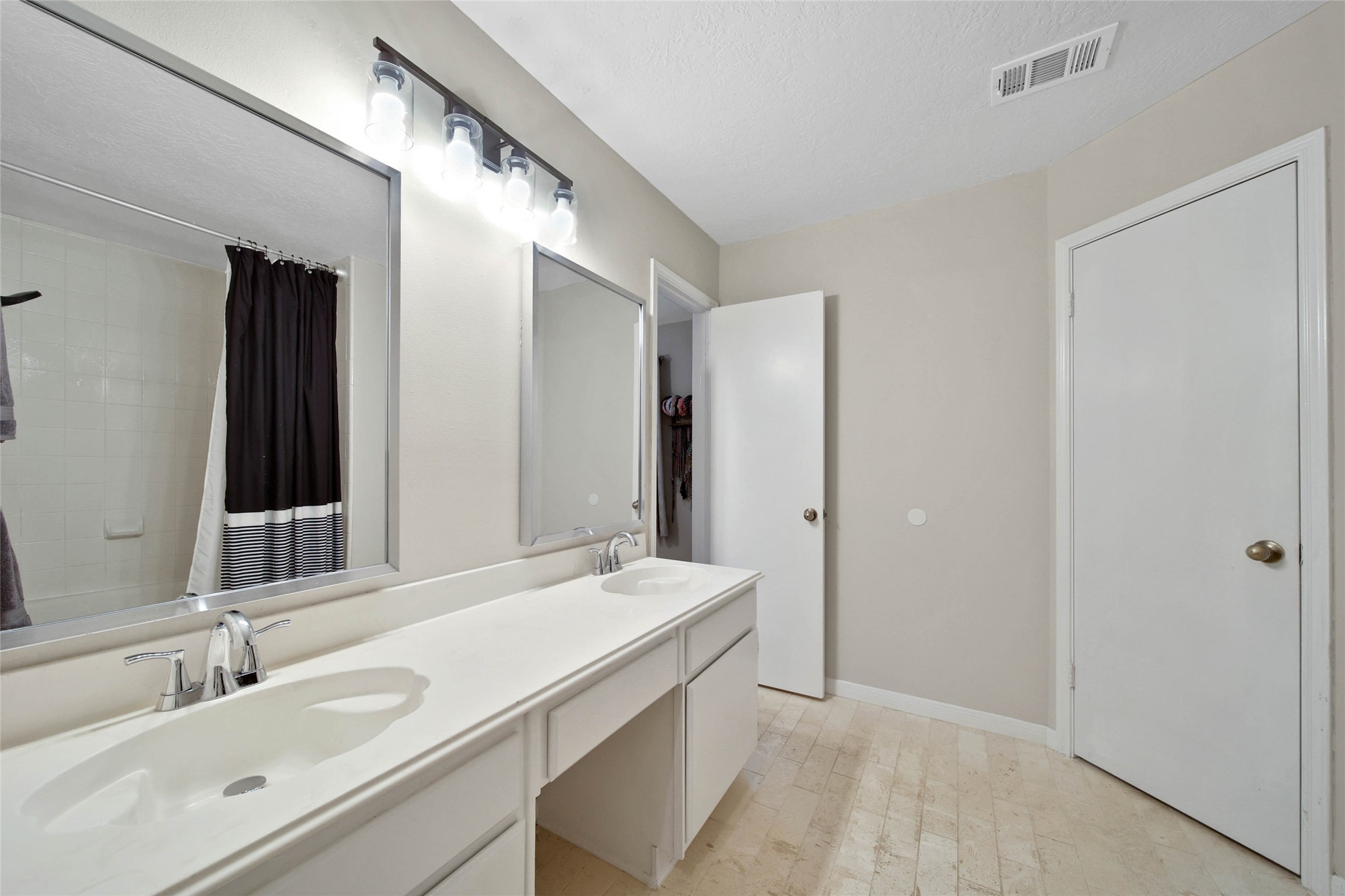 4843 Drew Forest Lane Humble, TX 77346 - Photo 24 of 37 Primary bathroom has two separate sinks with a vanity area in between.