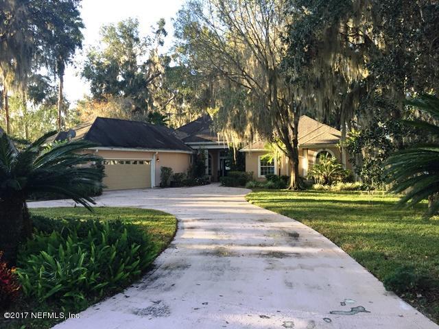 108 River's Edge Road North St. Augustine, FL 32092 - Photo 1 of 4 a front view of a house with a garden and trees