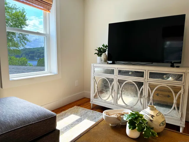 a bedroom with a bed and flat screen tv
