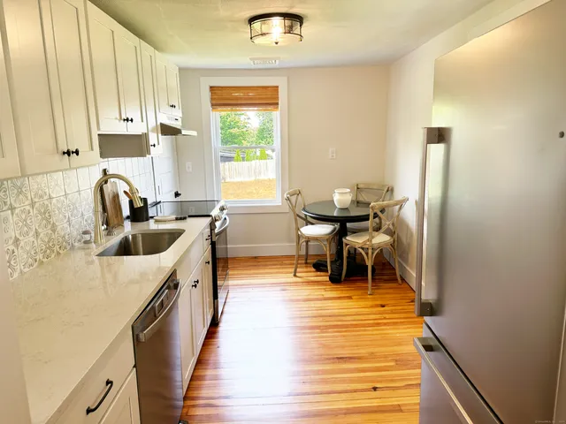 a kitchen with stainless steel appliances a sink a counter top space and cabinets