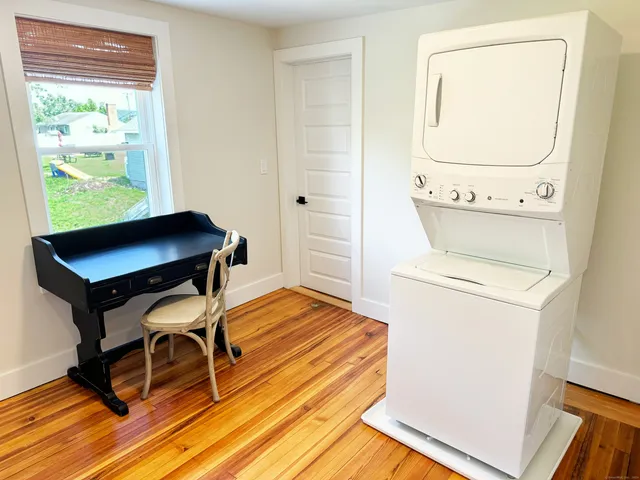 a workspace with wooden floor and a window