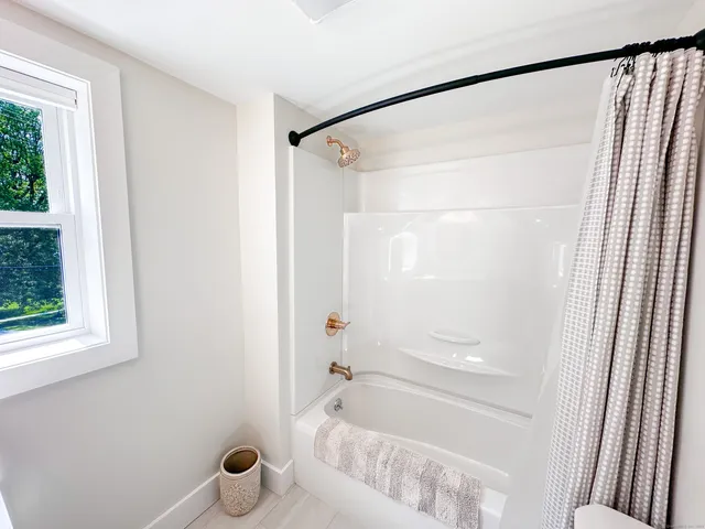 a bathroom with a shower and a tub