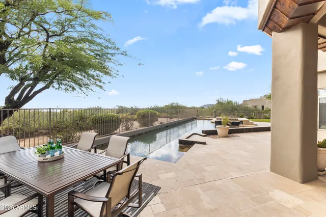 a living room with furniture large windows and wooden floor