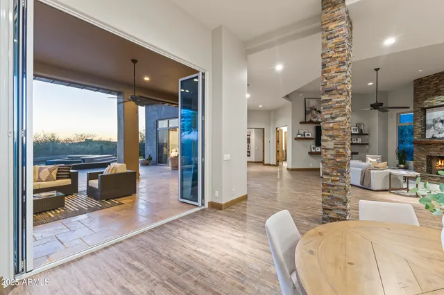 a living room with patio furniture and a floor to ceiling window