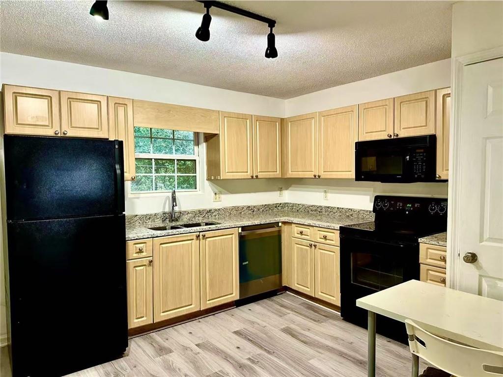 3665 Chestnut Drive, Unit F2 Atlanta, GA 30340 - Photo 15 of 21 a kitchen with granite countertop a refrigerator stove top oven and sink
