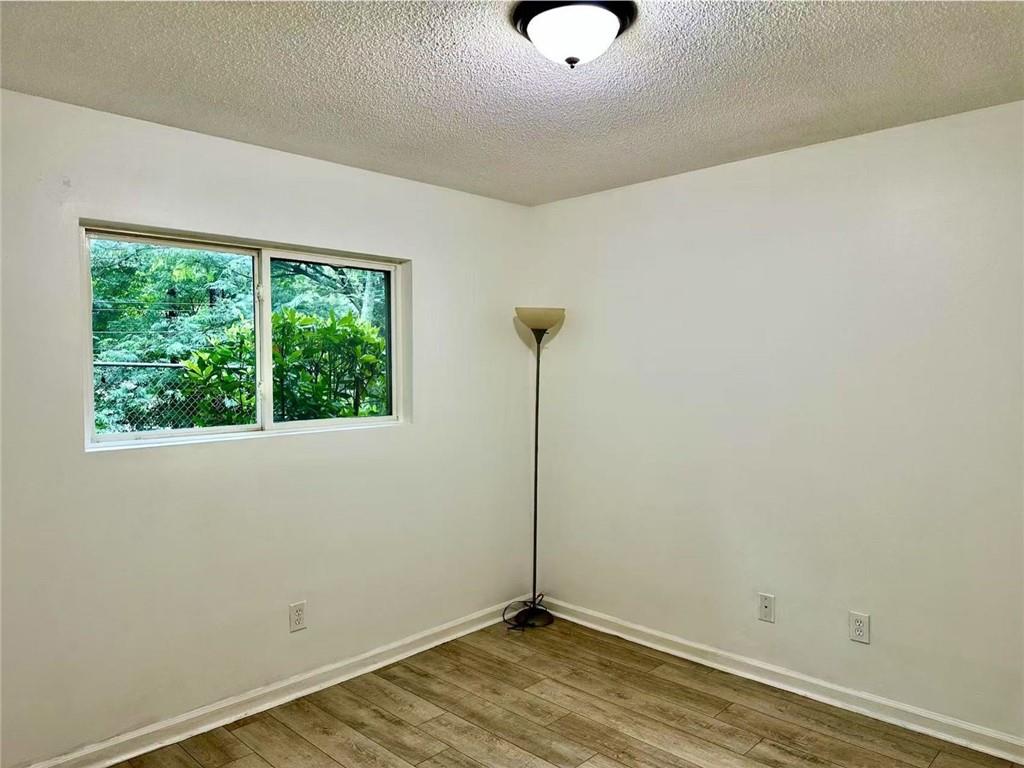 3665 Chestnut Drive, Unit F2 Atlanta, GA 30340 - Photo 18 of 21 a view of a room with wooden floor and fan