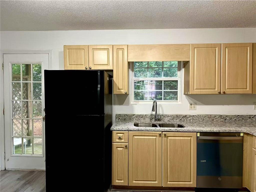 3665 Chestnut Drive, Unit F2 Atlanta, GA 30340 - Photo 21 of 21 a kitchen with granite countertop a refrigerator a sink and a window