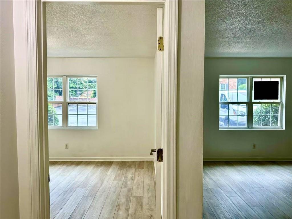 3665 Chestnut Drive, Unit F2 Atlanta, GA 30340 - Photo 7 of 21 an empty room with wooden floor and windows