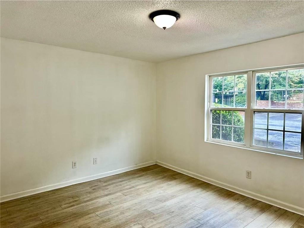 3665 Chestnut Drive, Unit F2 Atlanta, GA 30340 - Photo 10 of 21 an empty room with wooden floor and windows