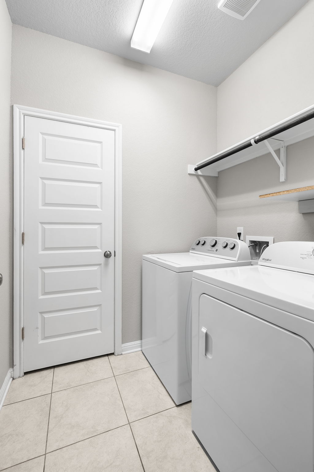 313 Mclintock Road Jarrell, TX 76537 - Photo 8 of 40 A dedicated laundry room provides convenience, featuring a shelf and rod for organization.