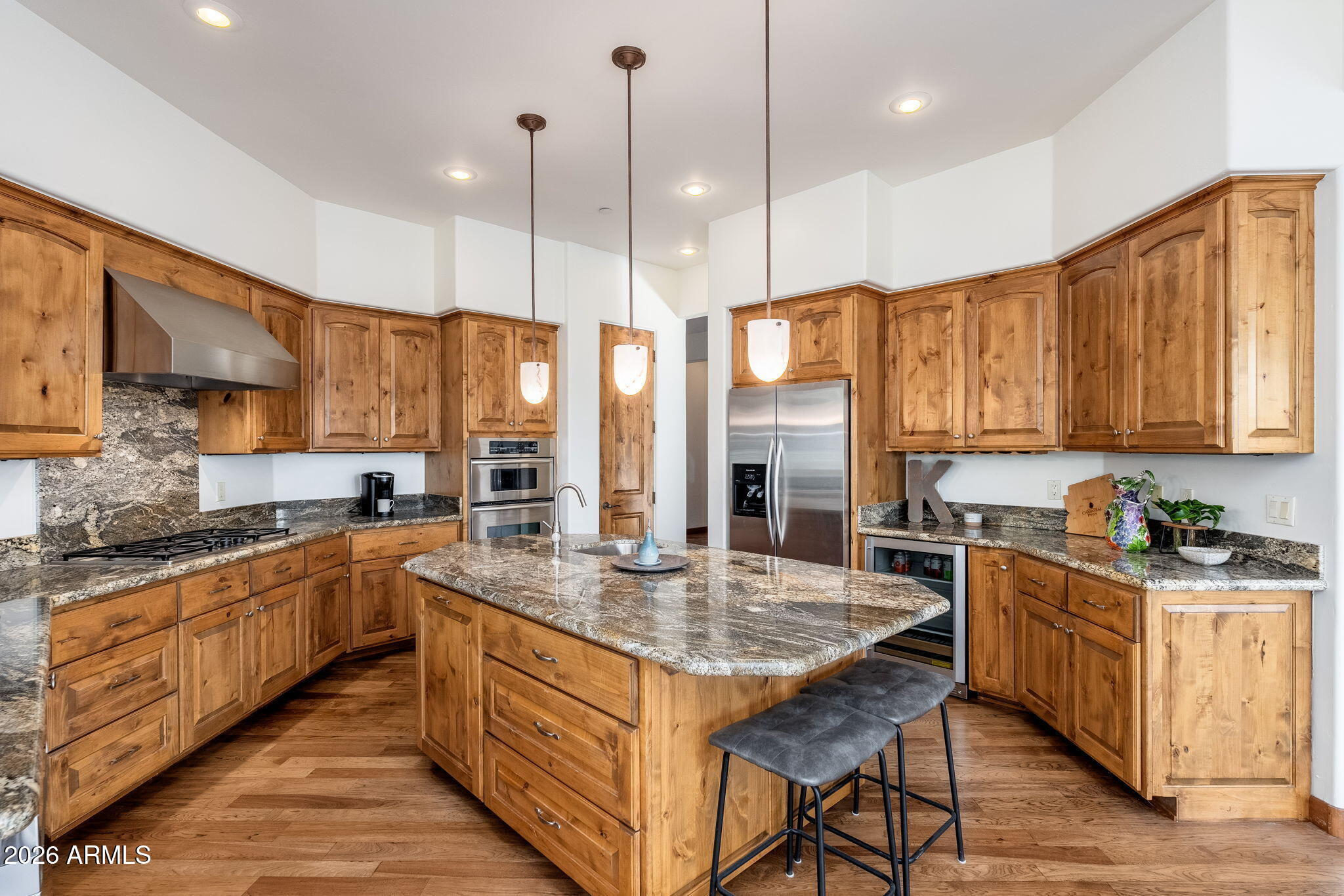 2208 East Filaree Circle Payson, AZ 85541 - Photo 10 of 60 a kitchen with stainless steel appliances granite countertop stove top oven a sink dishwasher and wooden cabinets with wooden floor