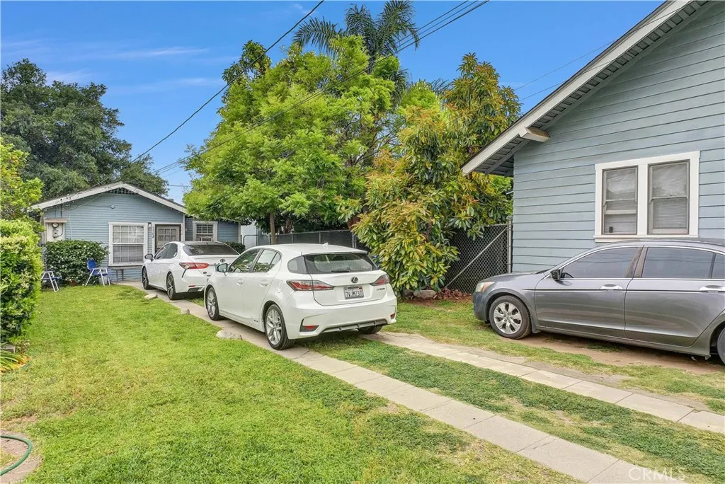 558 East 9th Street Upland, CA 91786 - Photo 2 of 10 a front view of a house with a garden and parking space
