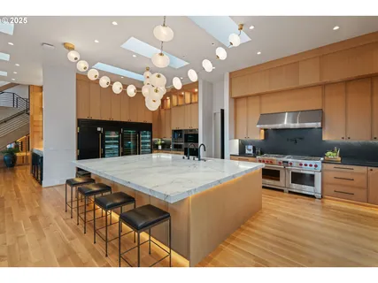 a large kitchen with a table and chairs