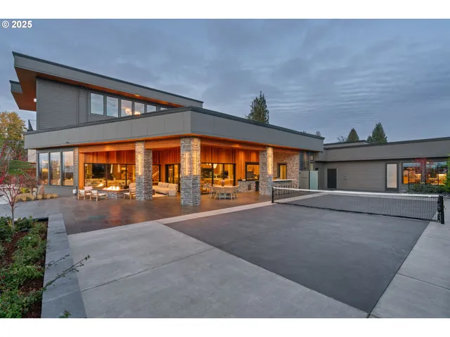 a large kitchen with stainless steel appliances a sink dishwasher a stove a refrigerator and cabinets