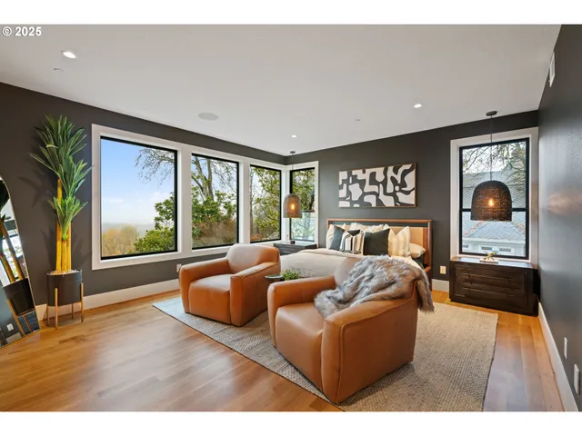 a living room with furniture a table and a large window