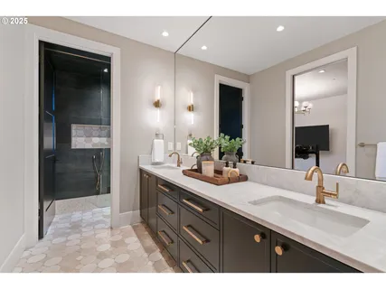 a living room with furniture a flat screen tv and kitchen view