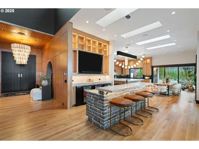 a living room with furniture a flat screen tv and floor to ceiling window
