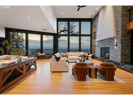 a living room with fireplace furniture and a large window
