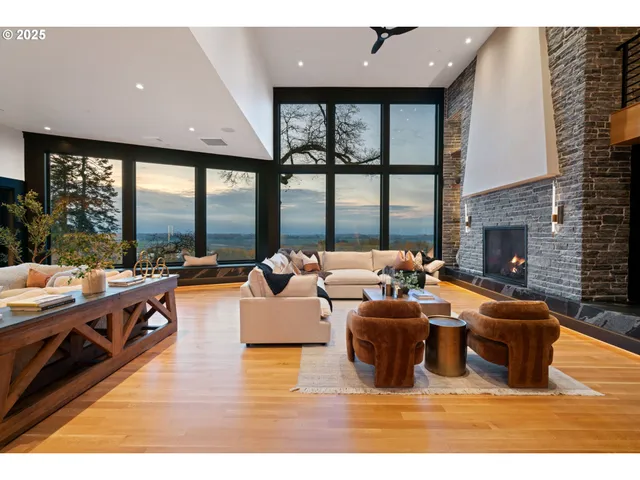 a living room with fireplace furniture and a large window