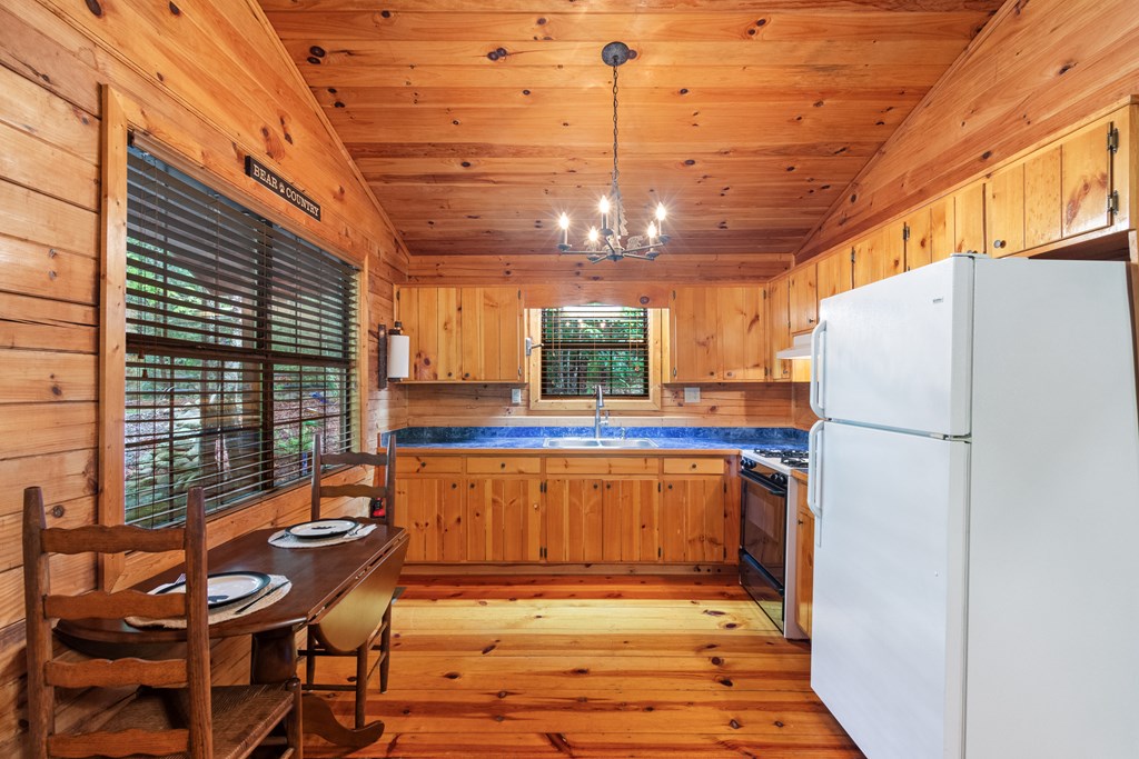 67 Tomahawk Trail Blue Ridge, GA 30513 - Photo 15 of 32 a view of a kitchen with a dining table and chairs